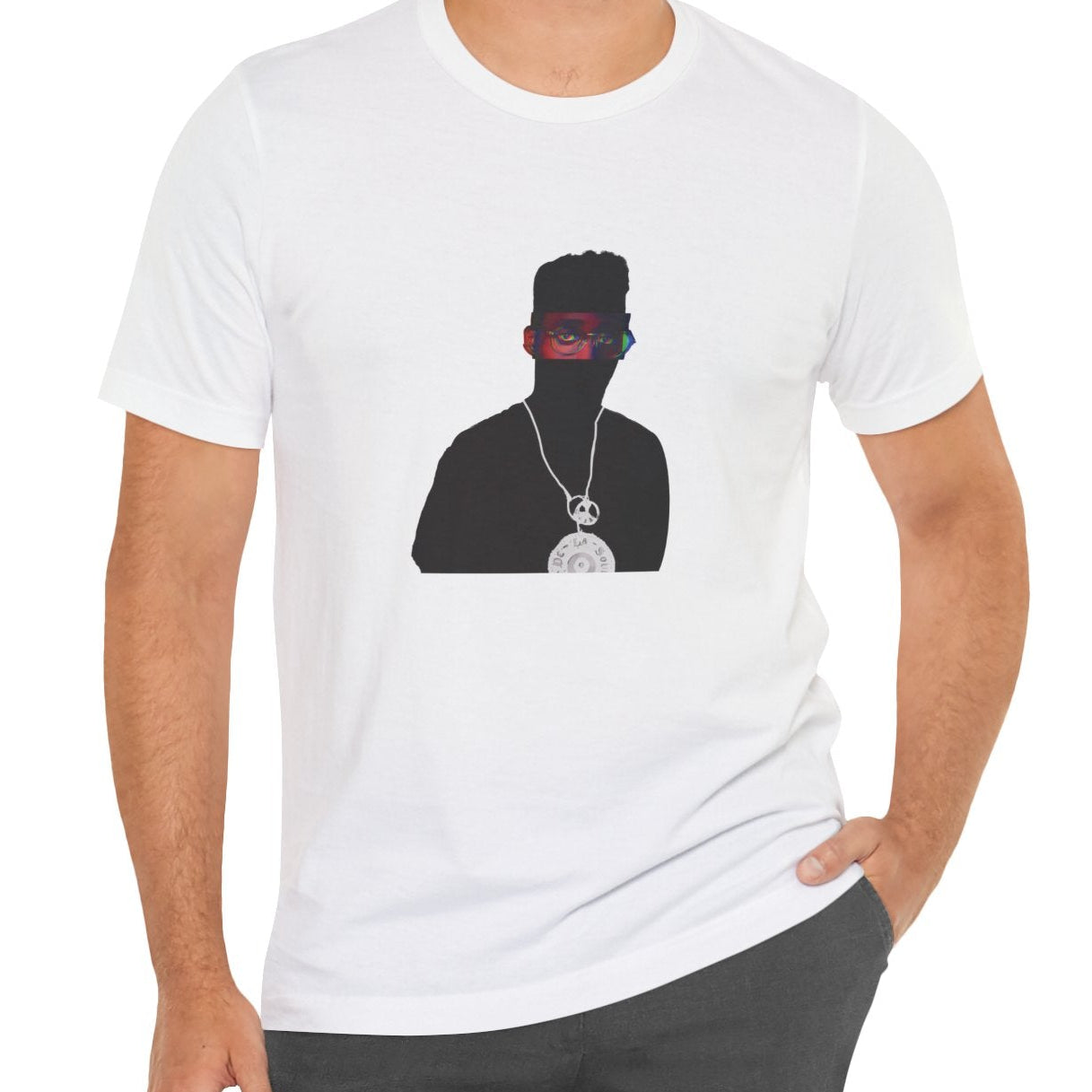 Alternative Hip-Hop music icon graphic t-shirt in gray featuring illustrated silhouette portrait design with high-top fade, round glasses, peace medallion and chain - worn by model in studio setting - IconBandwear music icons collection