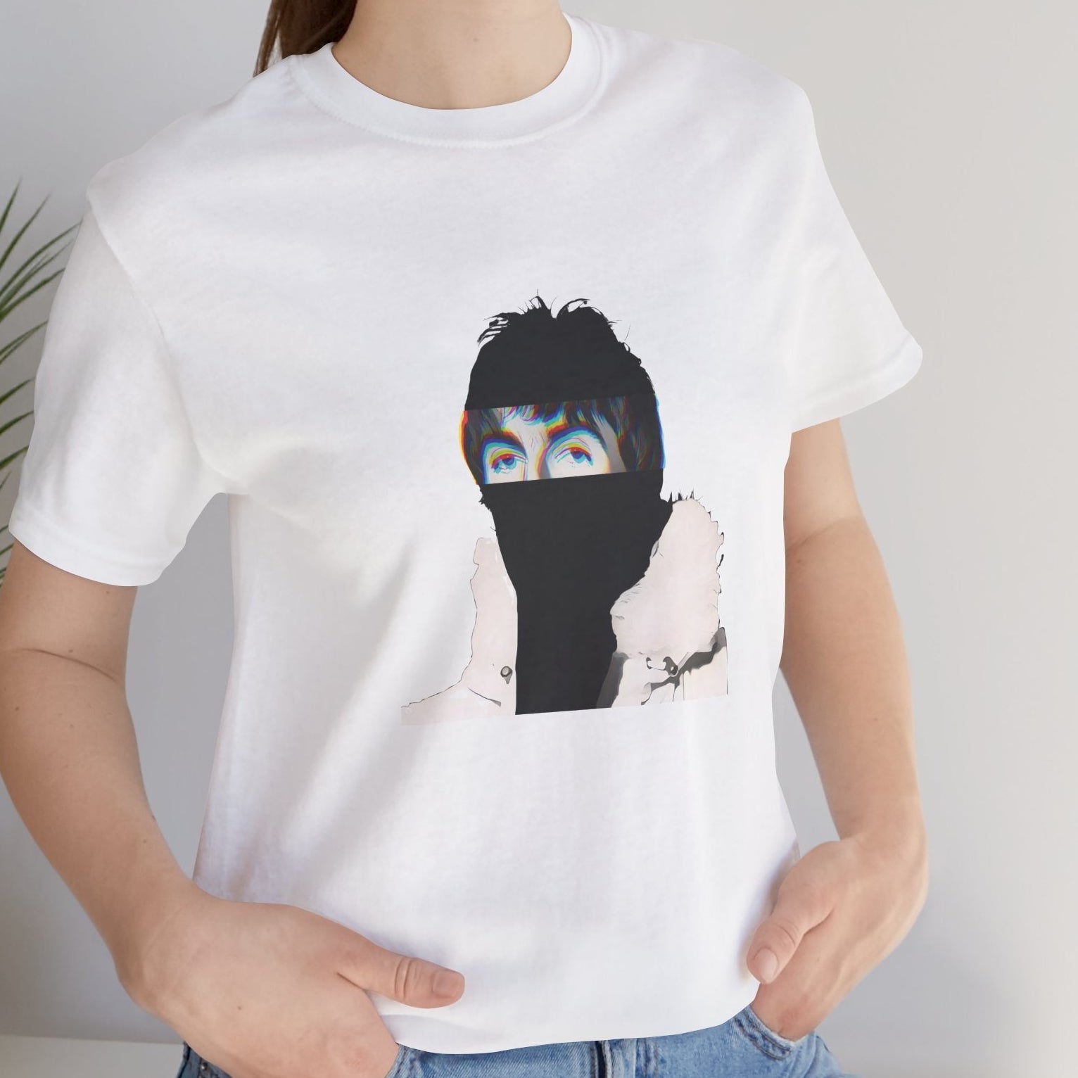 Britpop music icon graphic t-shirt in white featuring illustrated silhouette portrait with tousled dark hair, chromatic glitch effect and white fur-collared parka - styled by model in studio setting - 90s design - IconBandwear music icons collection
